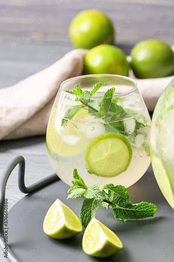 Glass of fresh mojito on table