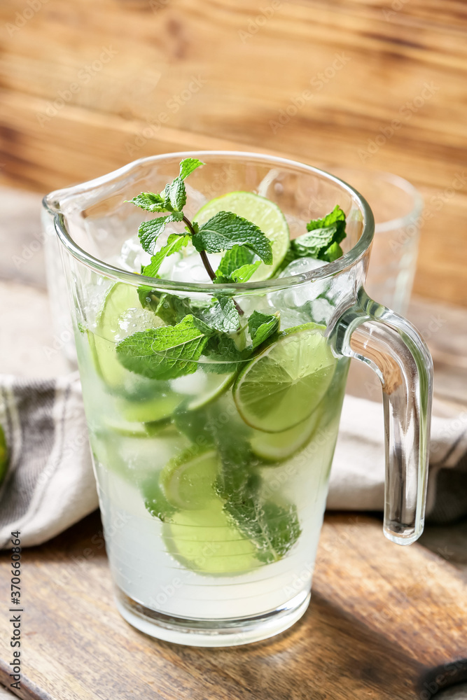 Jug of fresh mojito on table