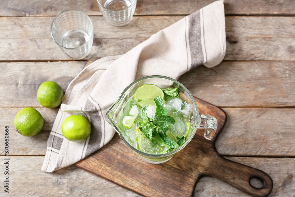 Jug of fresh mojito on table