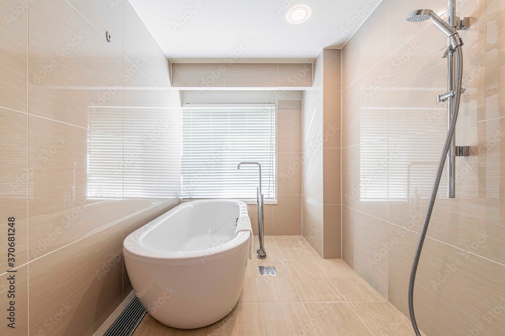 Shower room with external daylight window and modern white ceramic bath