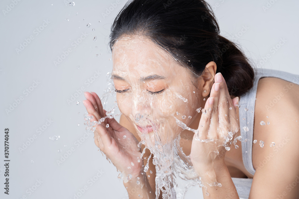 Beautiful female asian Wash face in studio