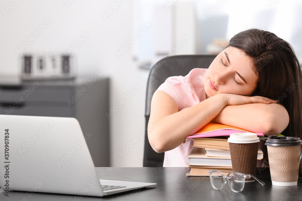 Tired student sleeping at table