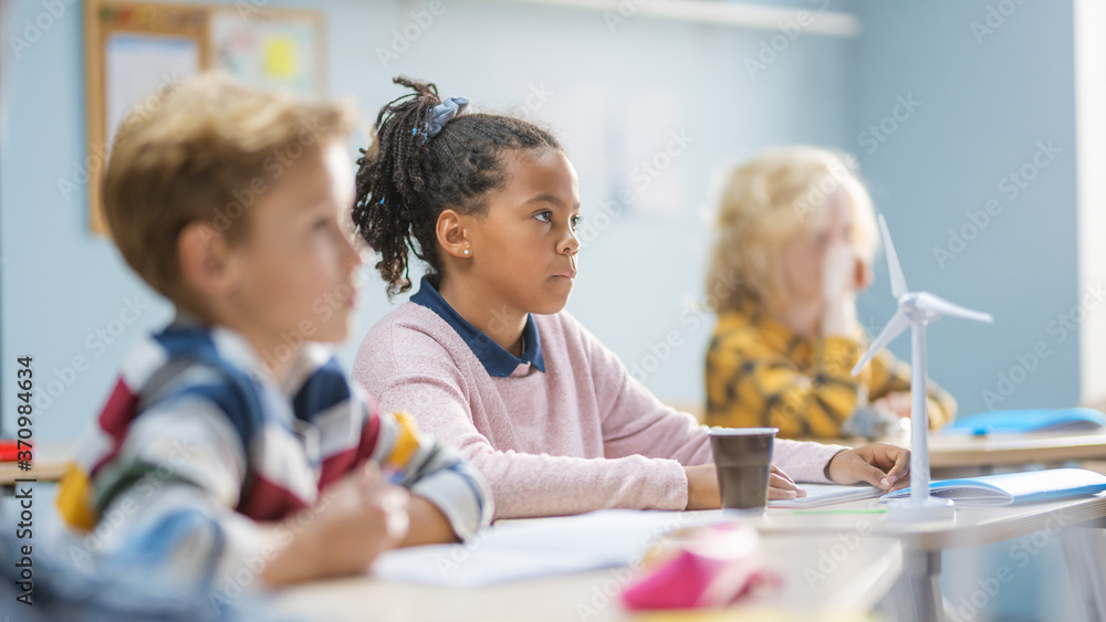 In Elementary School Classroom Brilliant Black Girl is Carefully Listening a Teacher. Junior Classro