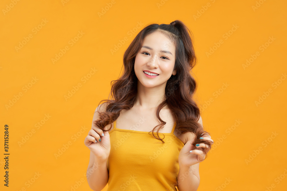 Portrait happy young asian woman feeling carefree laughing positive emotion on yellow background