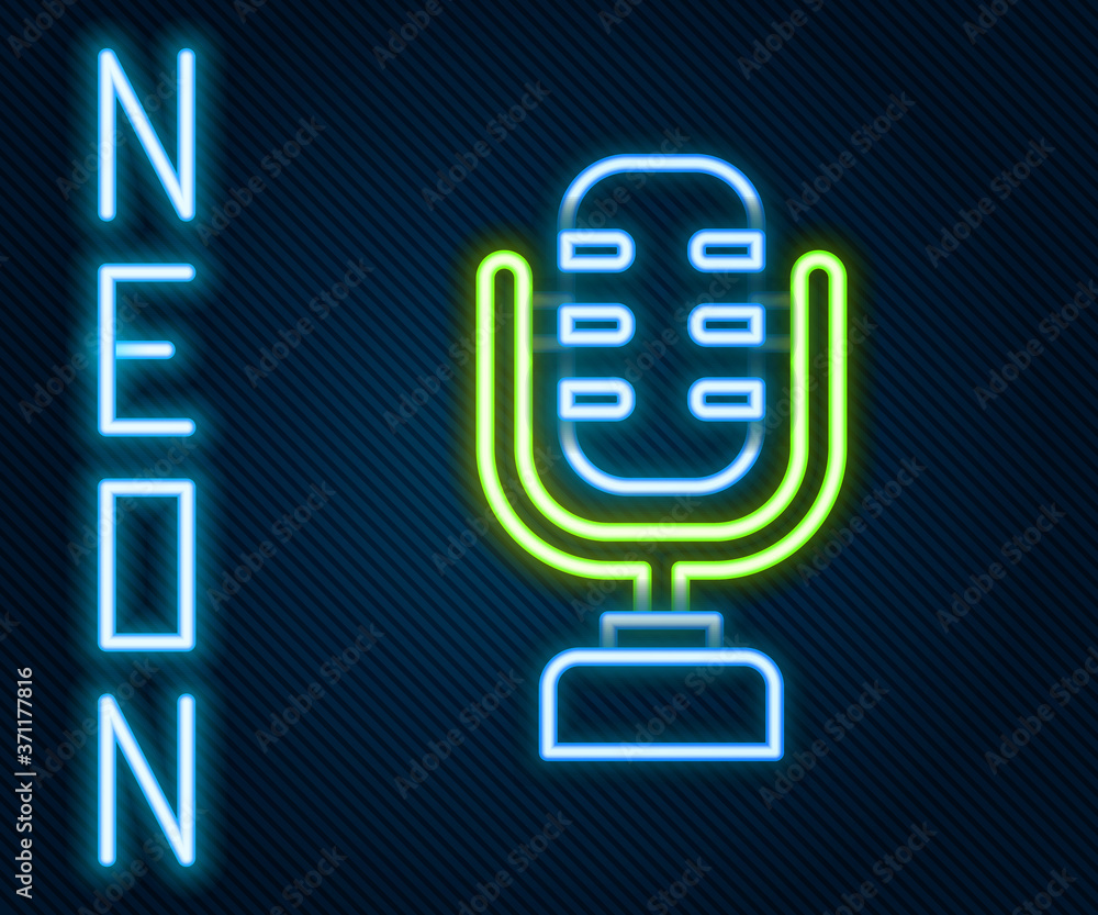 Glowing neon line Microphone icon isolated on black background. On air radio mic microphone. Speaker