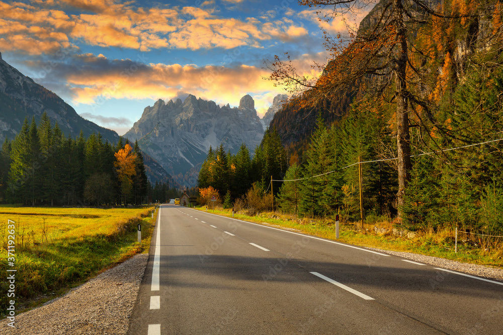 Idyllic mountain road through the Dolomites at sunset. Italy