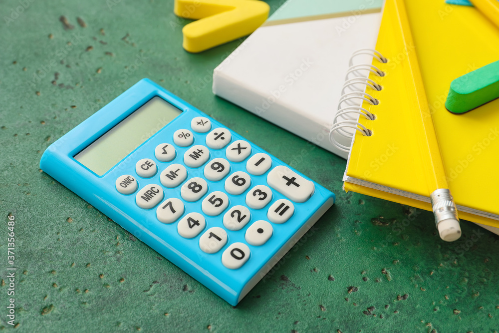 Set of school stationery and calculator on color background