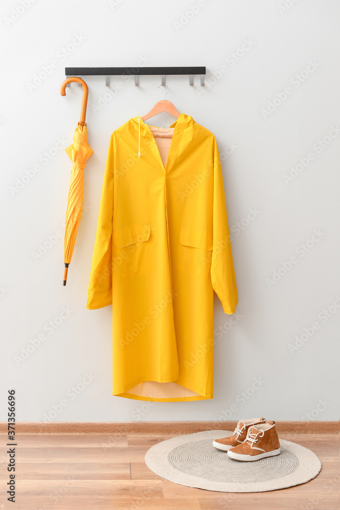 Raincoat and umbrella in hallway