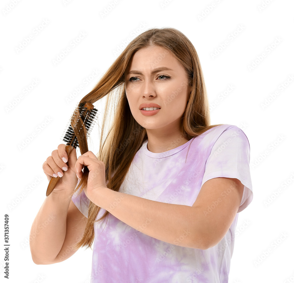 Stressed woman brushing hair on white background