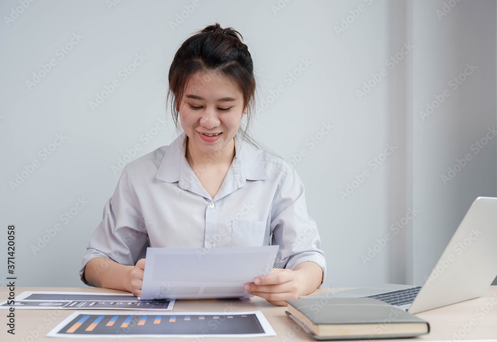 Portrait beautiful asian businesswoman working in her home, office, looking at graphs, financial mar