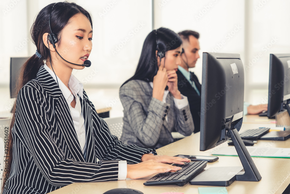 Business people wearing headset working in office to support remote customer or colleague. Call cent