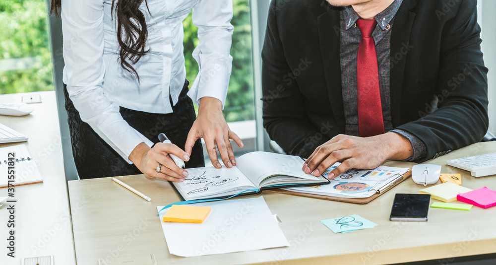 Two business people talk project strategy at office meeting room. Businessman discuss project planni