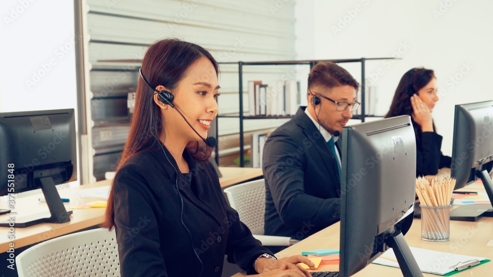 Business people wearing headset working in office to support remote customer or colleague. Call cent