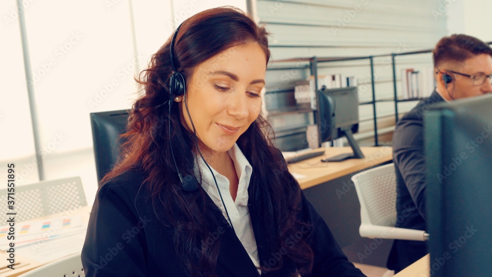 Business people wearing headset working in office to support remote customer or colleague. Call cent