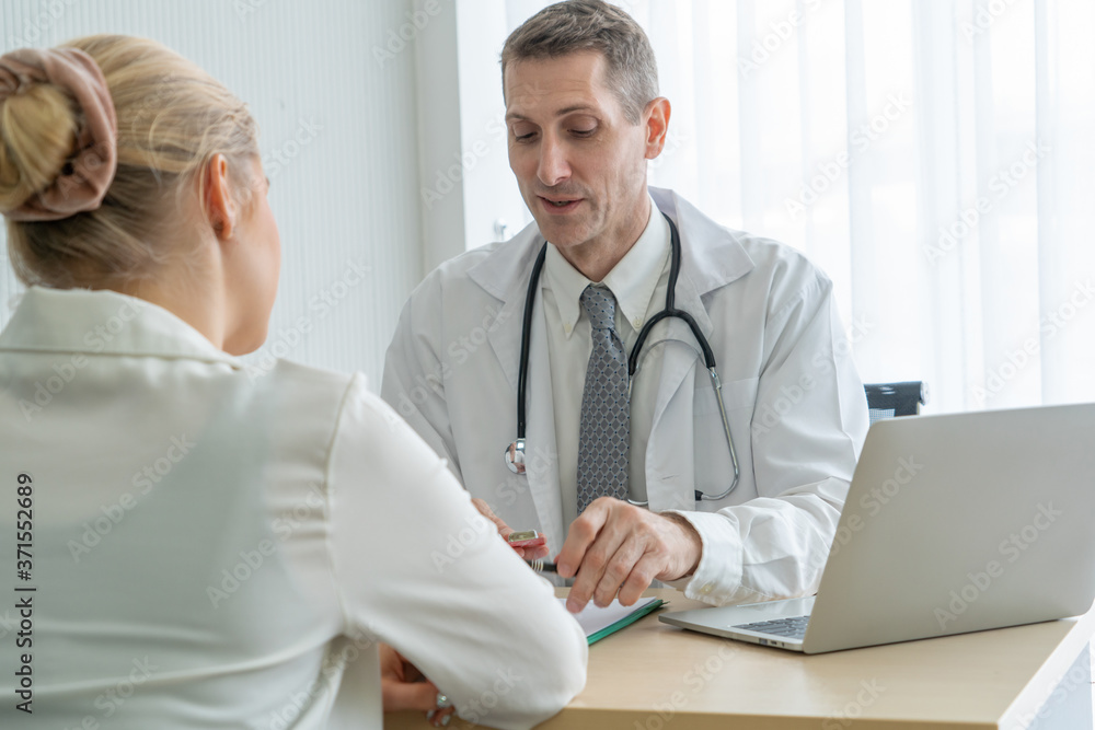 Doctor in professional uniform examining patient at hospital or medical clinic. Health care , medica