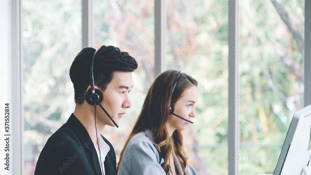 Business people wearing headset working in office to support remote customer or colleague. Call cent