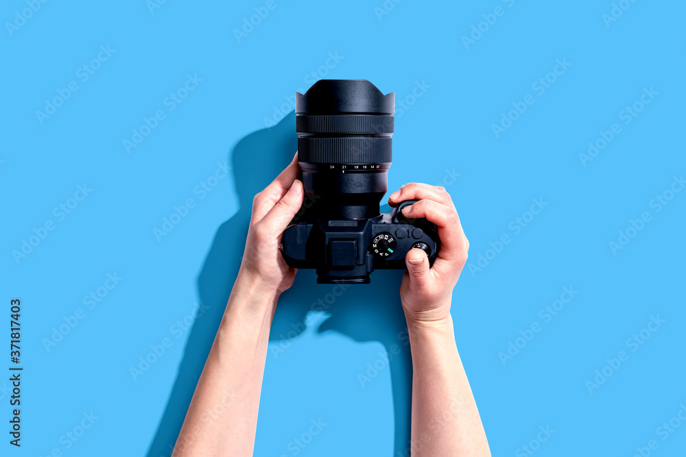 Person holding a SLR camera from above