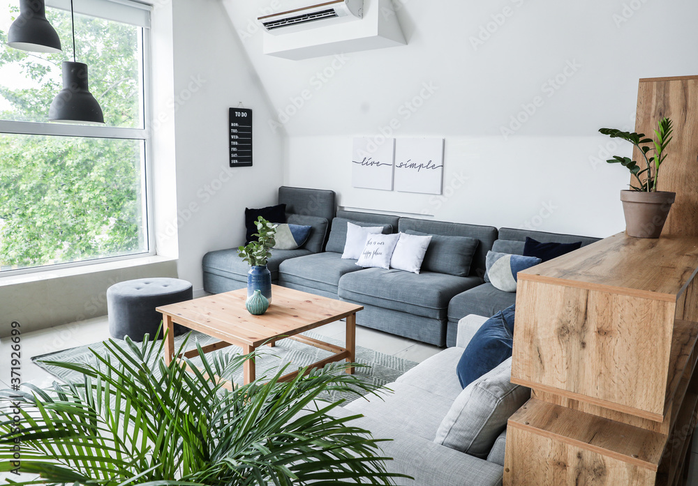 Stylish interior of living room with comfortable sofas and table