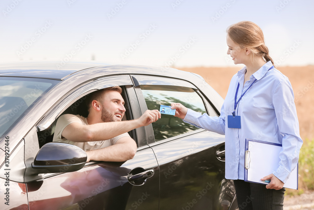 Man getting driver licence after passing test