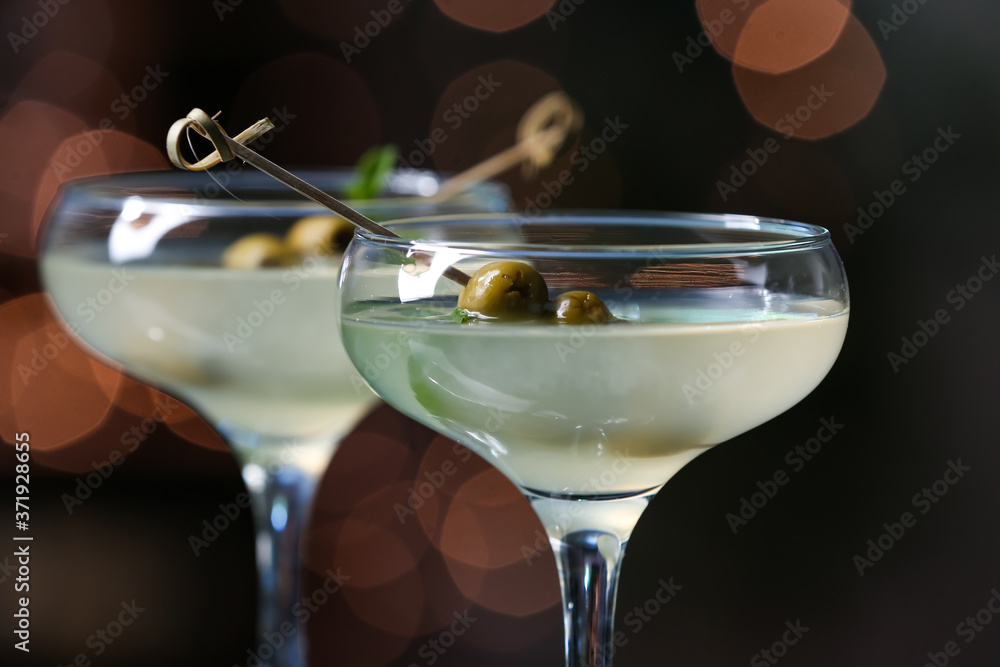 Glasses of fresh martini on dark background, closeup