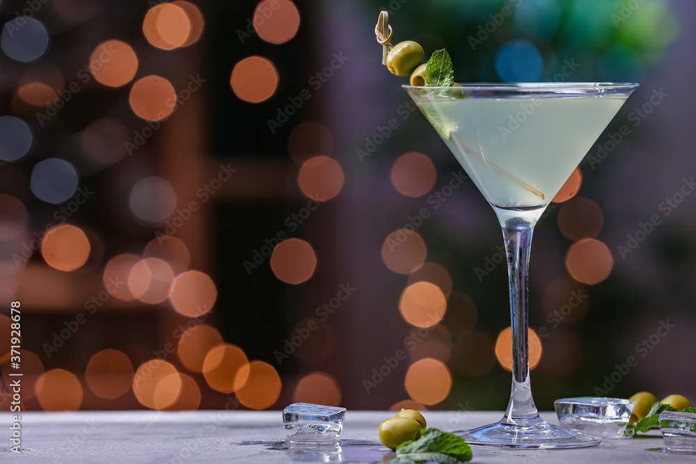 Glass of fresh martini on dark background