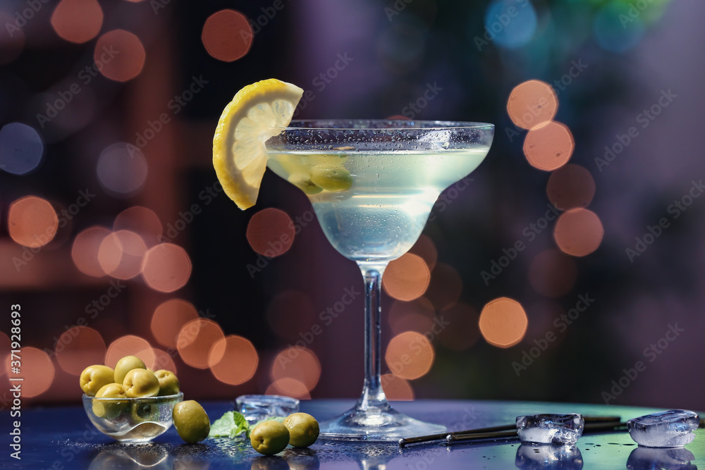 Glass of fresh martini on dark background