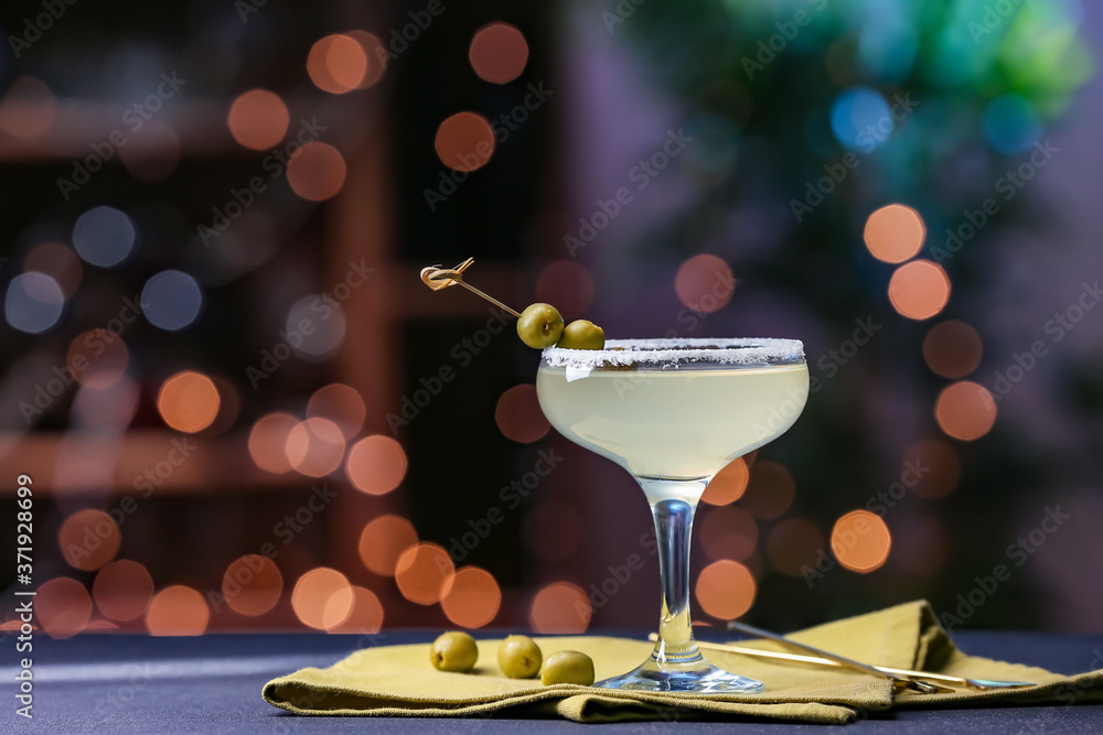 Glass of fresh martini on dark background