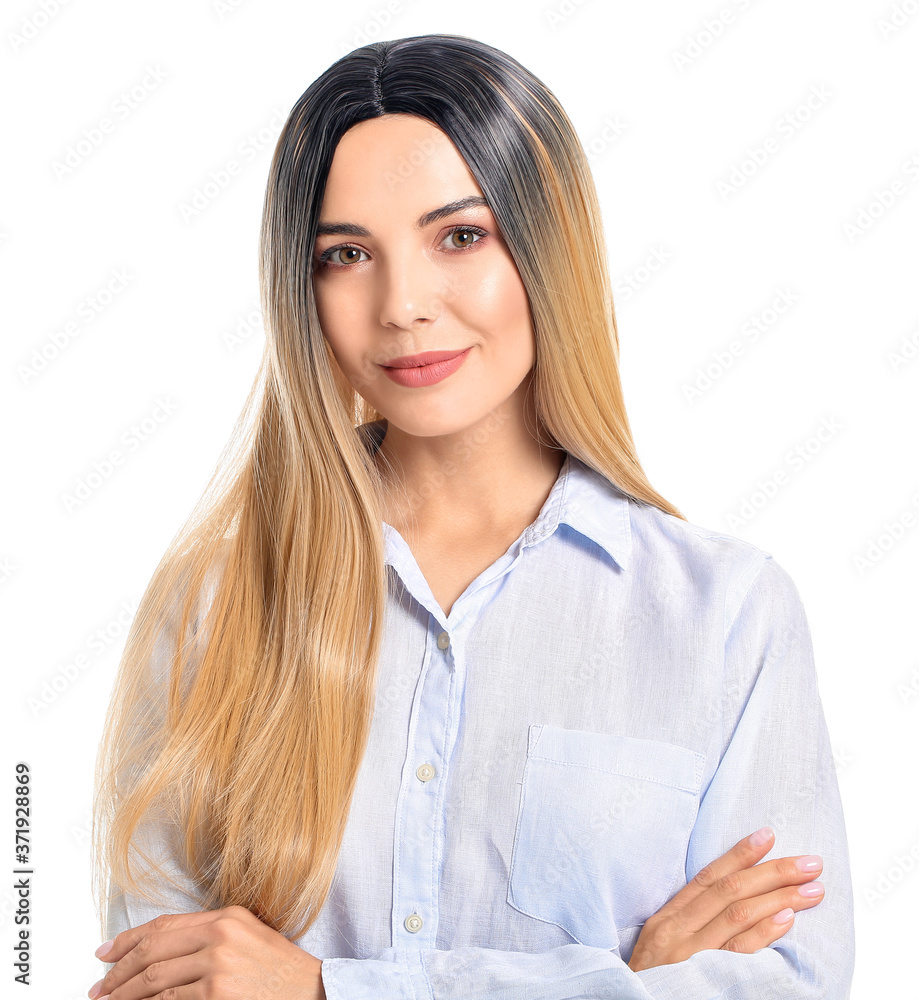 Beautiful young woman in wig on white background