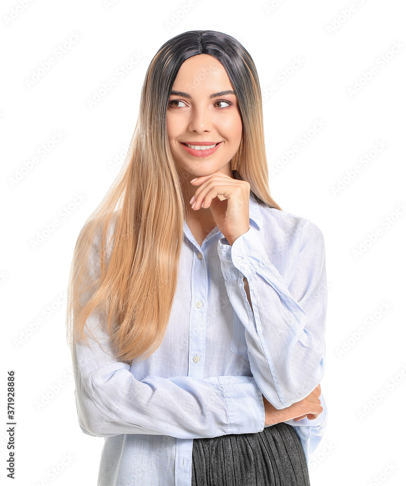 Beautiful young woman in wig on white background