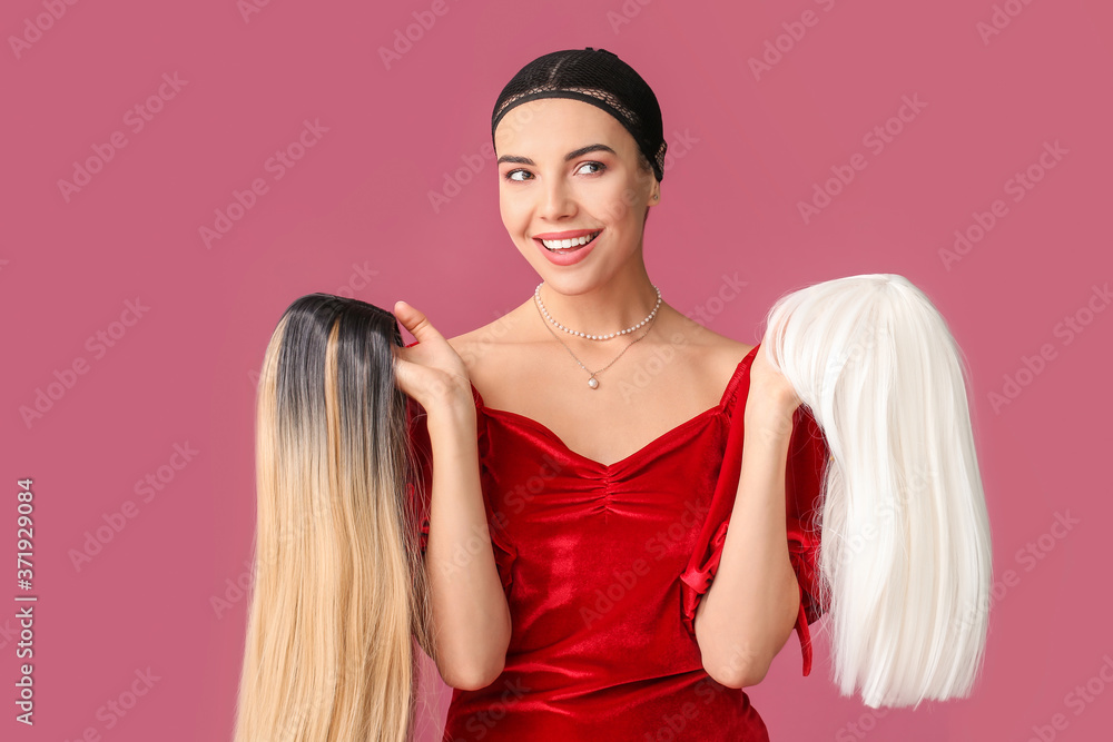 Beautiful young woman with different wigs on color background