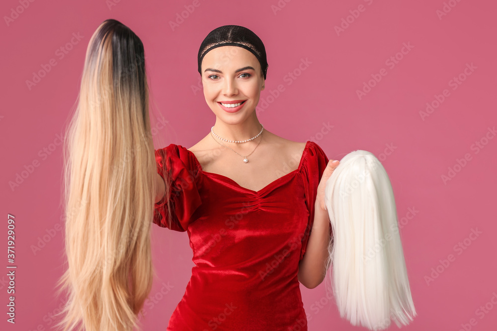 Beautiful young woman with different wigs on color background