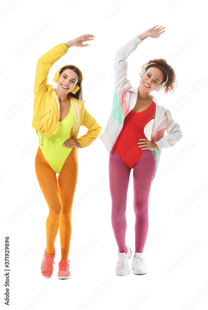 Young women doing aerobics on white background