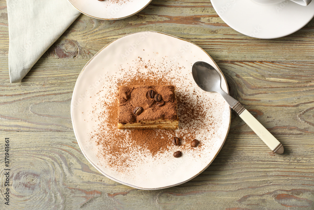 Plate with tasty tiramisu on table