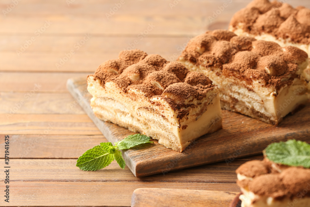 Tasty tiramisu on wooden background