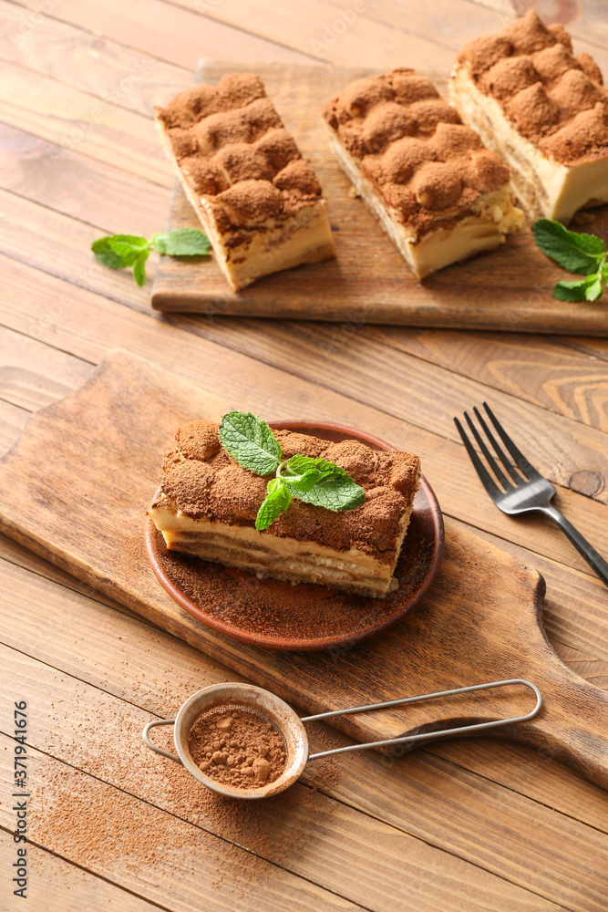 Tasty tiramisu on wooden background