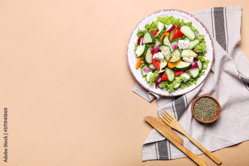 Plate with tasty cucumber salad on color background