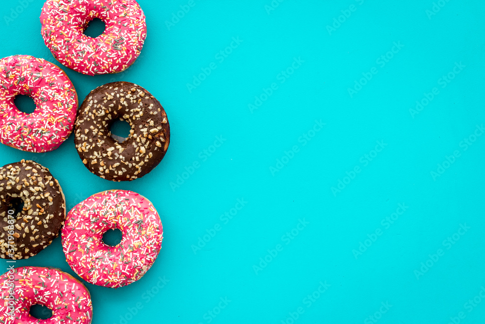 Top view of colorful glazed donut swith sprinkles, copy space