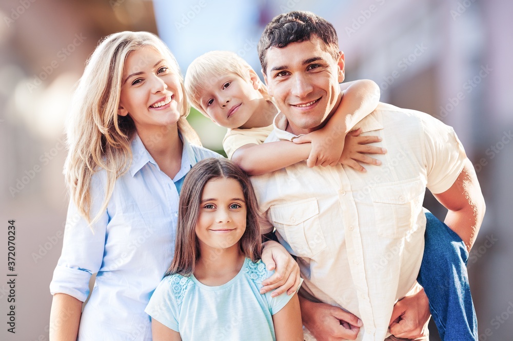 Beautiful smiling lovely family on outdoor background