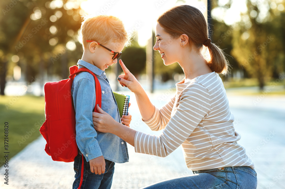 First day at school. mother leads  little child boy in grade