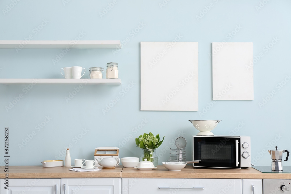 Set of utensils with microwave oven in kitchen