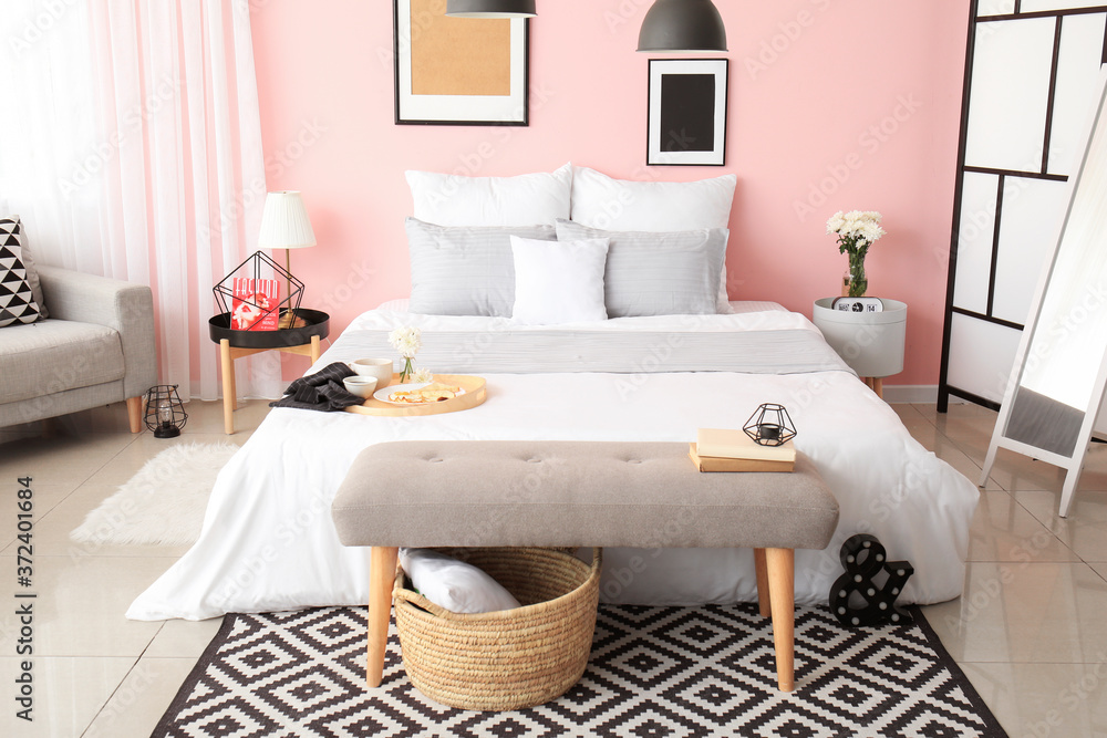 Big bed and bench in interior of modern room