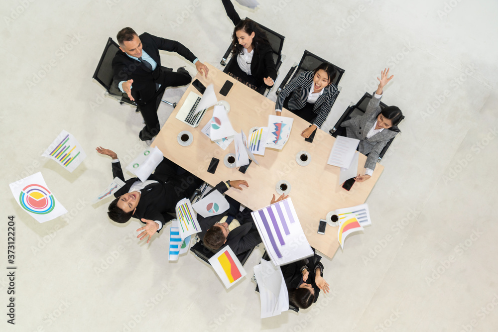 Successful business people celebrate together with joy at office table shot from top view . Young bu