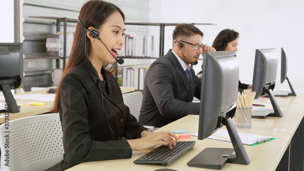 Business people wearing headset working in office to support remote customer or colleague. Call cent