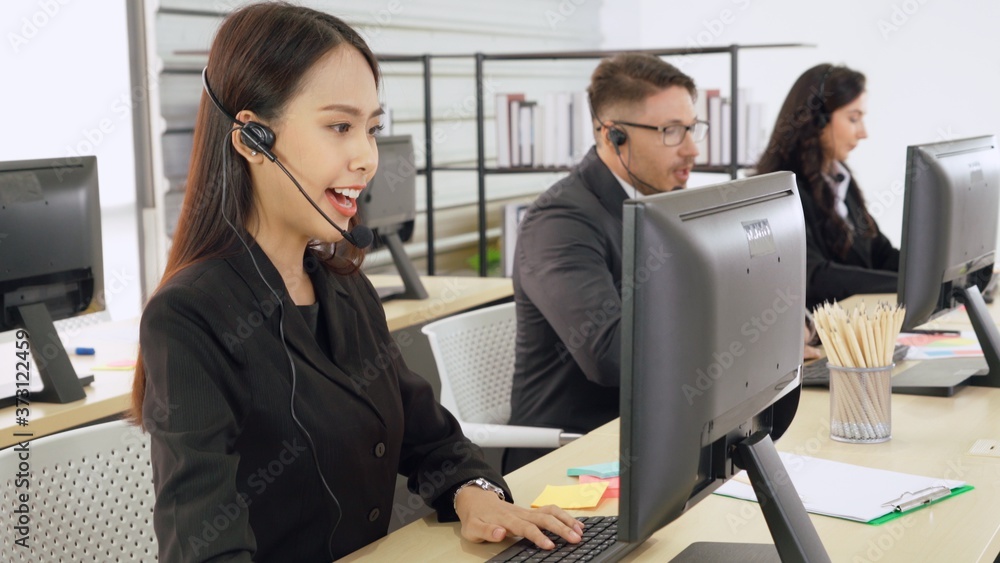 Business people wearing headset working in office to support remote customer or colleague. Call cent