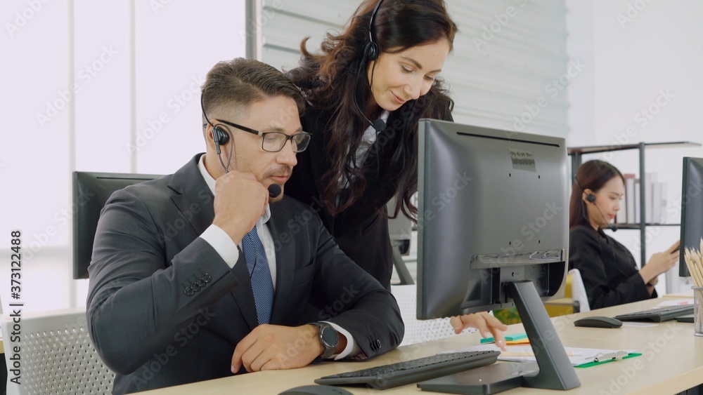 Business people wearing headset working in office to support remote customer or colleague. Call cent