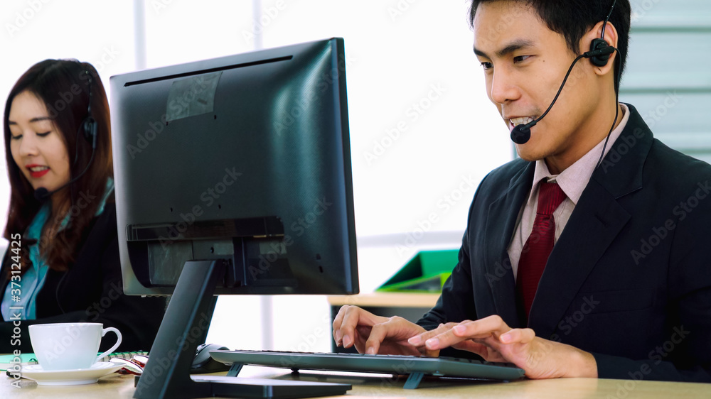 Business people wearing headset working in office to support remote customer or colleague. Call cent