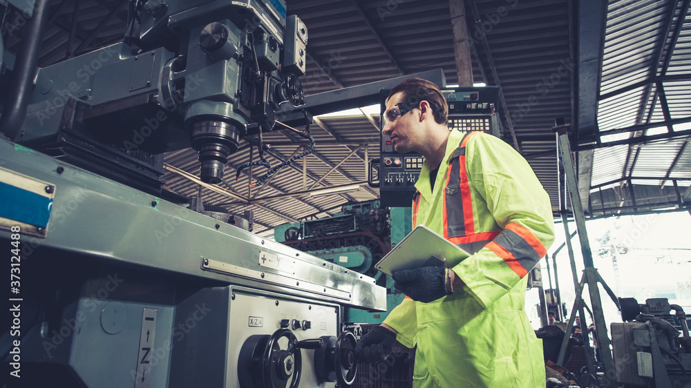 Smart factory worker using machine in factory workshop . Industry and engineering concept.