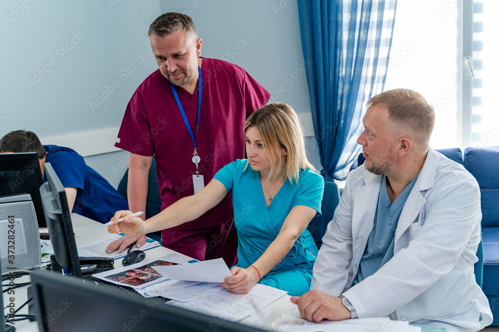 Medical specialists discussing medical diagnosis on computer screen. Specialists finding ways of hea