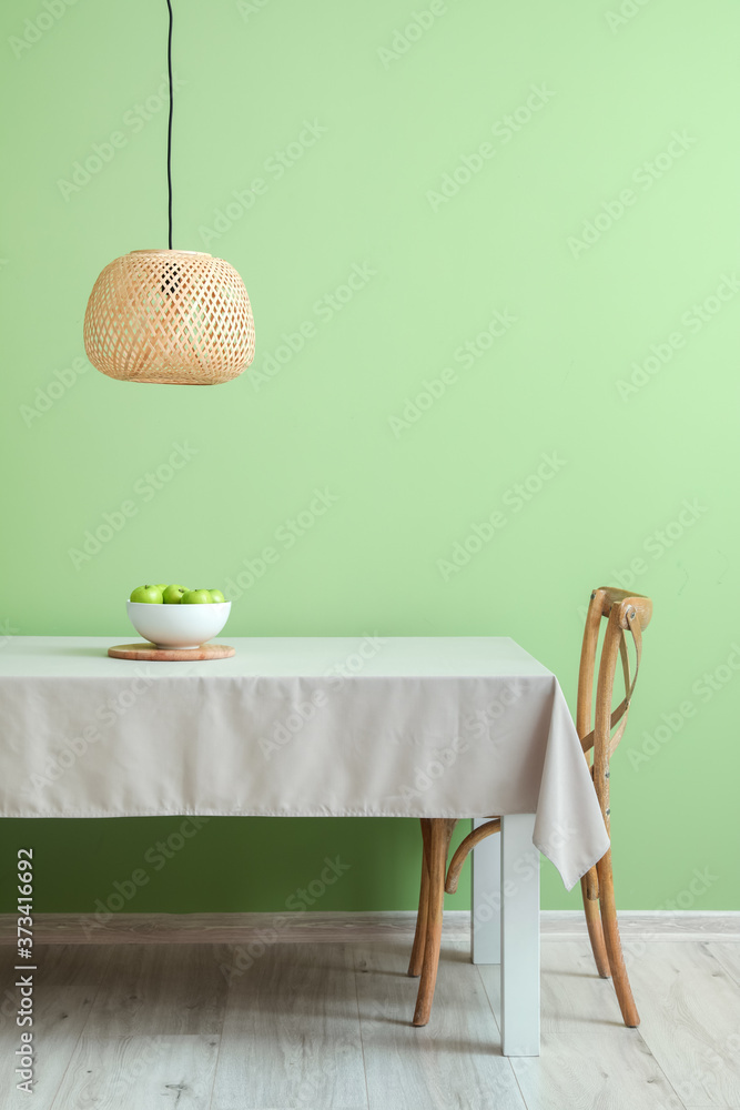 Table and chair near color wall