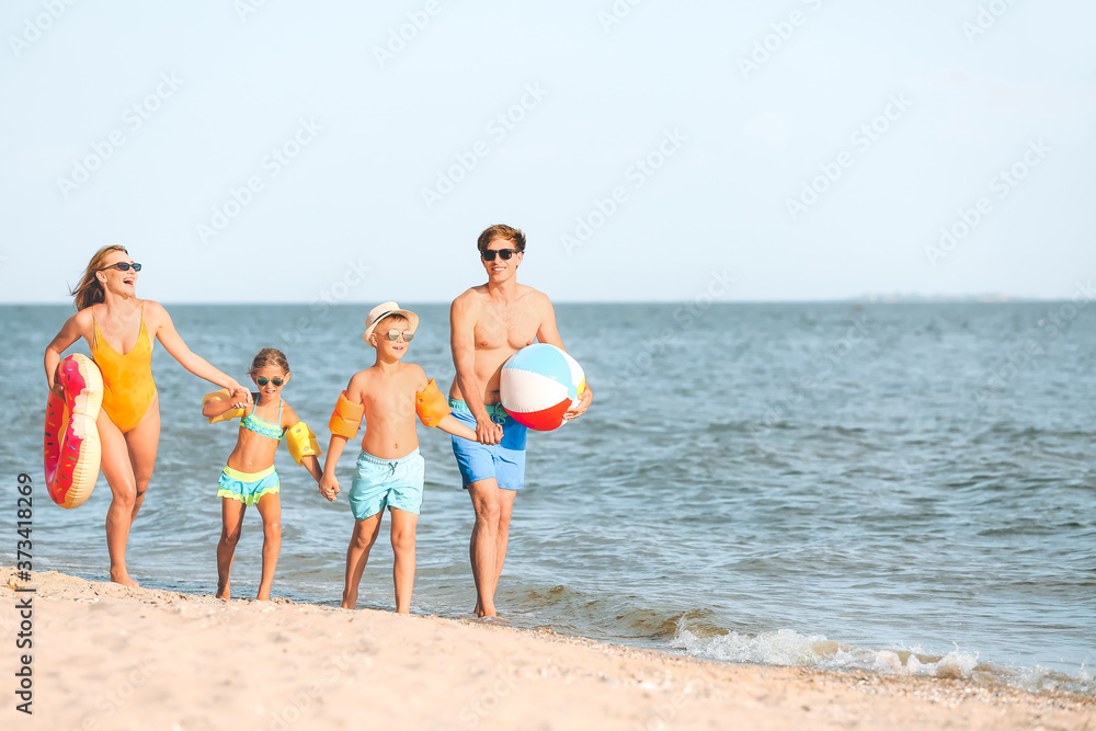 Happy family on sea beach at resort